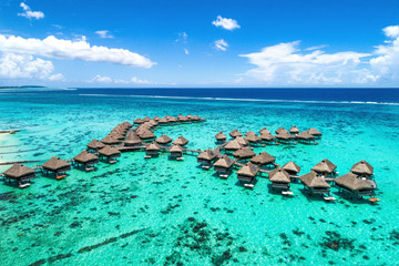 Beach travel vacation Tahiti hotel overwater bungalows luxury resort in coral reef lagoon ocean....