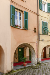 arches under bending medieval houses, Varese Ligure, Italy
