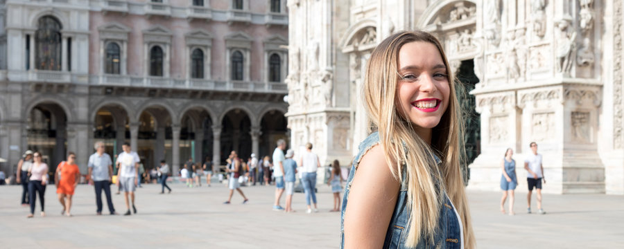 Pretty millennial teenager tourist visiting the city of Milan, in Italy