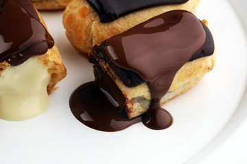 Traditional French dessert. Eclair with chocolate icing. Pastery concept