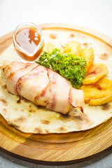 Dish with potatoes, ham and sauce