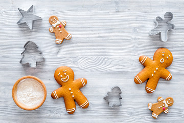 Gingerbread man on grey wooden background top view copyspace