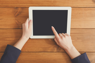 Female using tablet at workplace, top view, close up