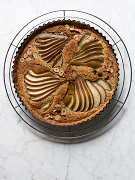Pear hazelnut frangipane tart on cooling rack