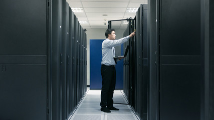 Fototapeta premium System administrator working in data center