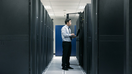 Fototapeta premium System administrator working in data center