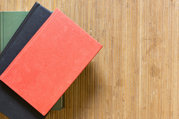 Several books on a mat of a brown color