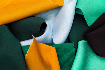 Pieces of yellow, green and blue textile.