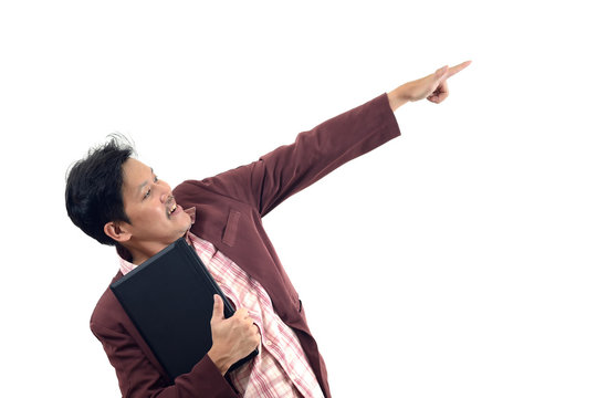 businessman holding a laptop and pointing and looking to his side isolate on white background