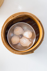 Top view fresh dumplings with hot steams on wood plate .Chinese food