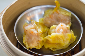 Top view fresh dumplings with hot steams on wood plate .Chinese food