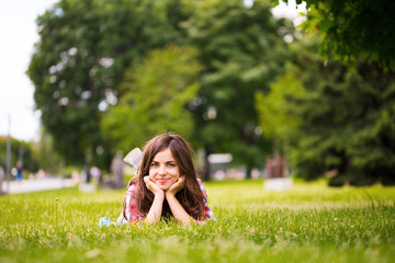 Naklejka na ściany i meble Girl on grass in the park.