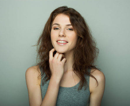 lifestyle and people concept: Young casual woman portrait. Clean face, curly hair. 