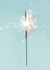 Christmas or New Year party sparkler on colourful background. Festive Magic sparks lights for...