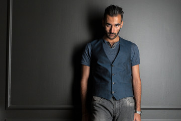 man standing over dark wall background