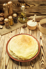 Stack of pancakes,One plain pancakes,Breakfast,snacks.Pancakes Day.Stack of kefir (buttermilk) pancakes,High stack of pancakes . Breakfast for the whole family.With copy space.Shallow DOF