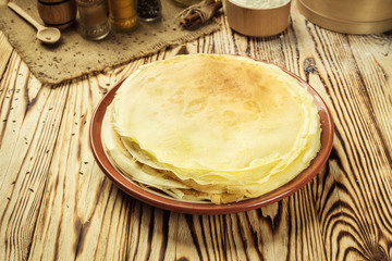 Stack of pancakes,One plain pancakes,Breakfast,snacks.Pancakes Day.Stack of kefir (buttermilk) pancakes,High stack of pancakes . Breakfast for the whole family.With copy space.Shallow DOF