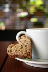 Coffee cup with an integral biscuit on a wooden base