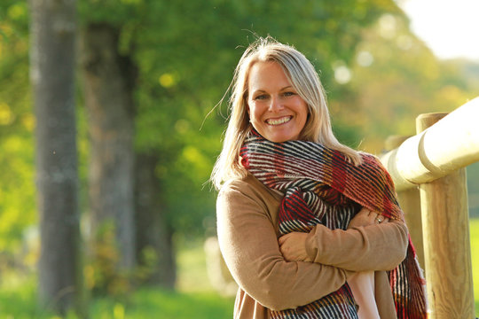 Happy  mature woman enjoys leisure time in autumn