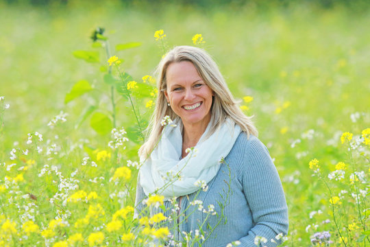 happy mature woman  in a flowerfield