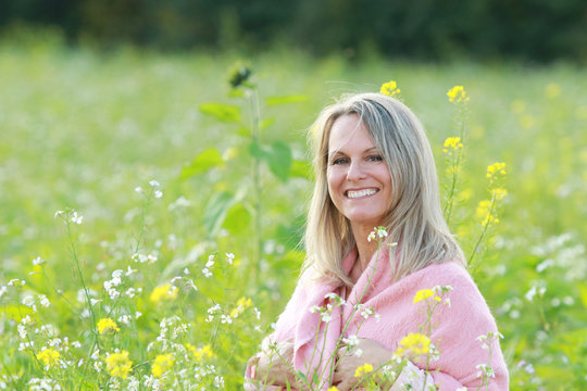 happy mature woman  in a flowerfield
