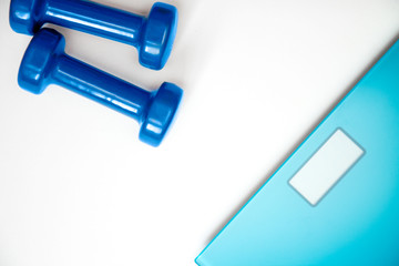 Fototapeta premium scales and dumbbells on a white