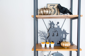 A rustic wooden shelf decorated for Halloween. 