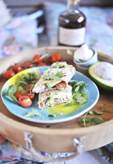 roll of pita bread on the grill. stuffing with fish and salad. avocado and olive oil. dinner on a wooden tray. healthy food.