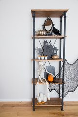 A rustic industrial shelf with Halloween decorations. 