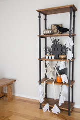 A rustic industrial shelf with Halloween decorations. 