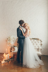 wedding in European style, beautiful couple in the Studio with a small dog