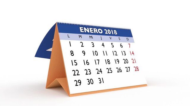 monthly sheets passing in a desk calendar for 2018. new year 2018 calendar in spanish
