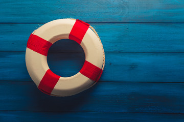 life saver on a blue wooden background