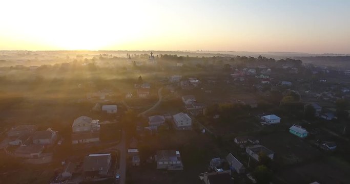 Air view of the village with fog, inium, church and river