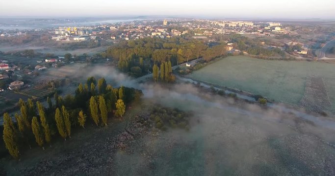 Air view of the village with fog, inium, church and river