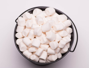 White mini marshmallows background close-up texture. Food background. Copy space.