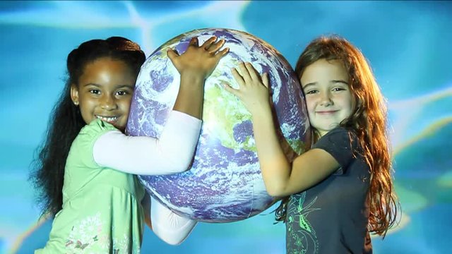 Young girls hug globe, aquatic background