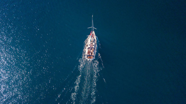 Aerial view of sailing boat on open sea.