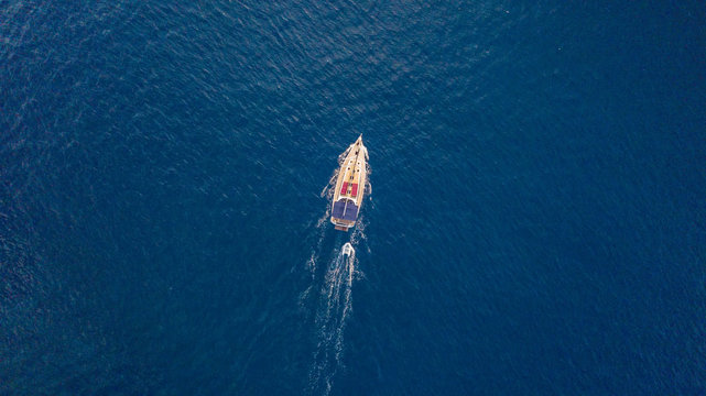 Aerial view of sailing boat on open sea.