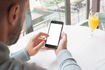 User touch mobile phone display. Isolated screen for mockup. Coffee in background.