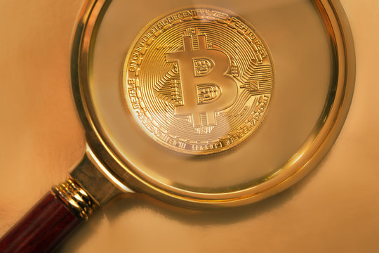 looking through a magnifying glass on new golden bitcoin