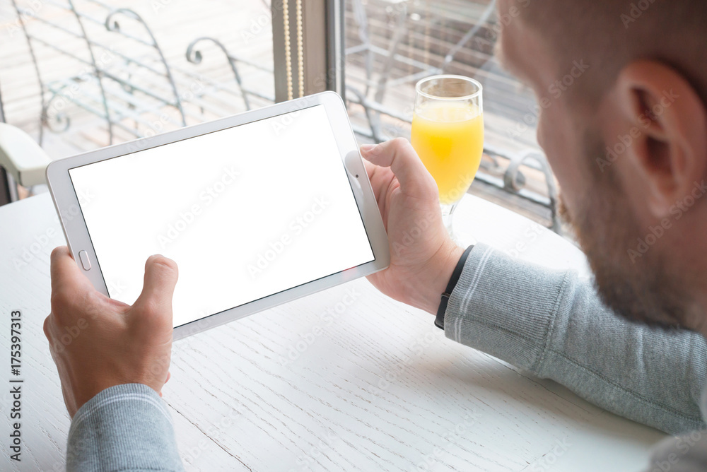 Poster Tablet mockup. Guy hold tablet in horizontal position. App or responsive web site design promotion.