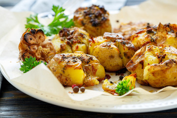 Potatoes baked in their skins with spices closeup.