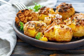 Baked potatoes with spices, olive oil and garlic.