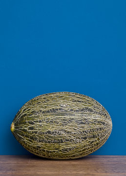 piel de sapo melon against blue  wall