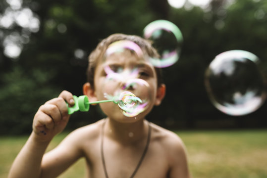 Child playing with bubble soap