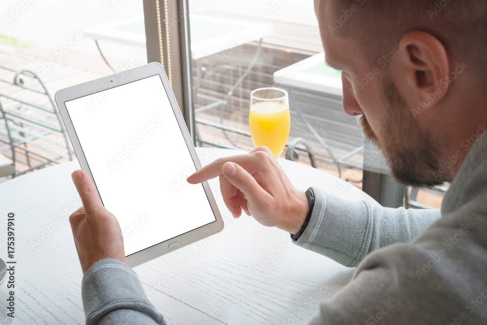 Aufkleber tablet mockup. man holding tablet in vertical position. touch screen with right hand. modern coffee 