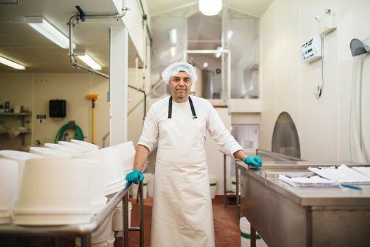 Middle age man standing and smiling in kitchen