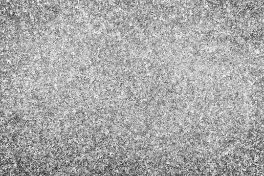 Close-up of natural granite stone abstract texture background with vignetting in black and white.