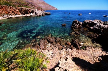  Paradise sea bay with azure water, beach and rocks. View from coastline trail of Riserva naturale dello Zingaro. Trapani province, Sicily, Italy.